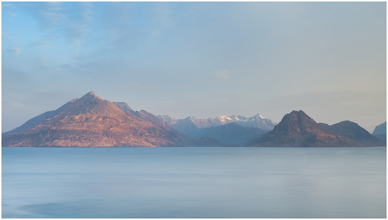 The snow-capped peaks of Sgùrr a' Ghreadaidh catching the sunrise at Elgol, Isle of Skye