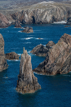 Tall sea stacks come out of the sea surrounded by high cliffs at Mangersta on Isle of Lewis.