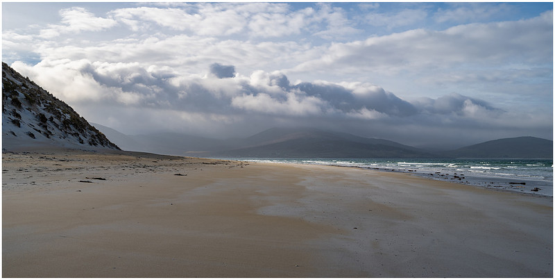 Early light over Luskentyre beach with waves, clouds and mountains, Isle of Harris, Scotland.