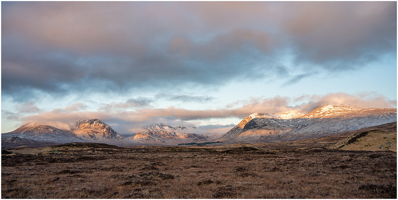 The first of the sunrise light catches the tops of the mountains, Black Mount, Rannoch Moor, Scotland.
