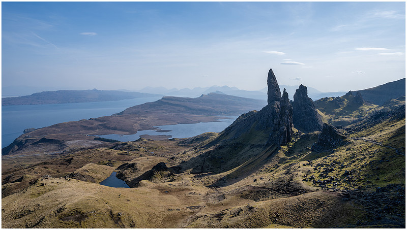 High up photograph of the Old Man of Storr showing sea and mountains on Isle of Skye.