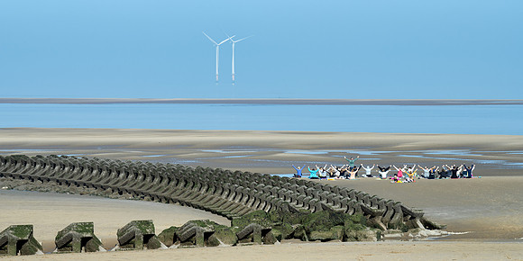 Humans make like a windmill on the shores at New Brighton.