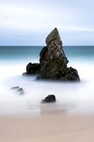Long exposure image of Beach rock formations on Durness Beach at Sango Bay in Scotland with waves crashing.