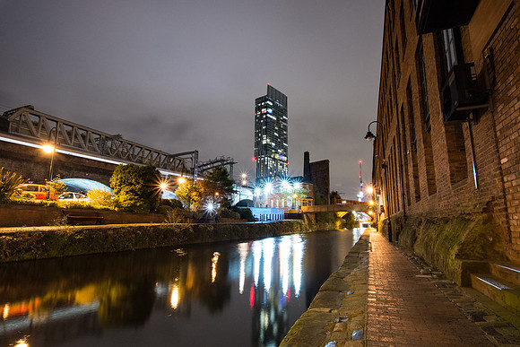 City lights and Beetham Tower reflected in the Bridgewater canal at Castlefield in Manchester.