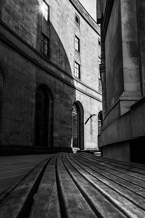 Black and white image of the curved wooden seating at the Manchester Library.