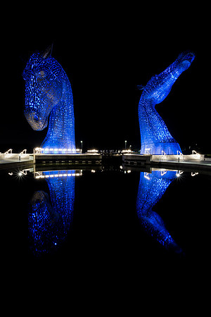 Night time with blue lights at The Kelpies, Falkirk, Scotland.