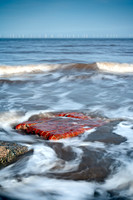 A small section of brick wall in the sea close to the gun emplacements at Godwin battery, Spurn Point, Yorkshire.