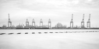 Long exposure of birds on sea defences and a boat unloading at Liverpool Docks.