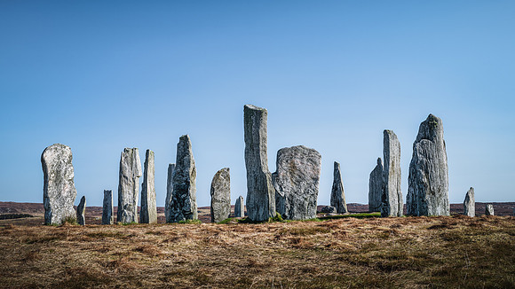 Callanish standing stones casting shadows on a sunny day on the Isle of Lewis, Scotland.
