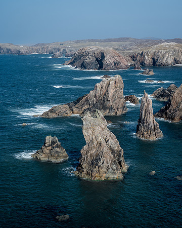 Tall sea stacks come out of the sea surrounded by high cliffs at Mangersta on Isle of Lewis.