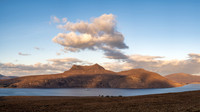 Sunset at Beinn Ghobhlach on Little Loch Broom in Scotland with a Boat on the loch.