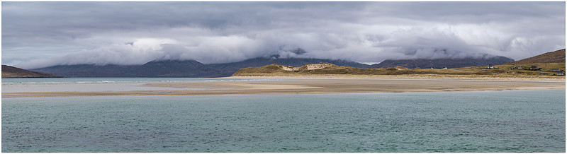 Classic Outer Hebrides cloud topped mountains behind Luskentyre’s dunes, Lewis and Harris, Scotland.