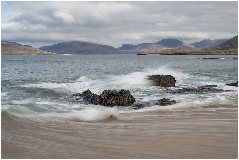 Waves retreat down the steep beach at Bagh Steinigidh, Isle of Harris, Scotland.