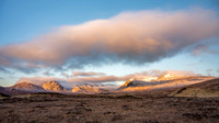 Sunrise lights up the snow covered Black Mountains on Rannoch Moor in Scotland.